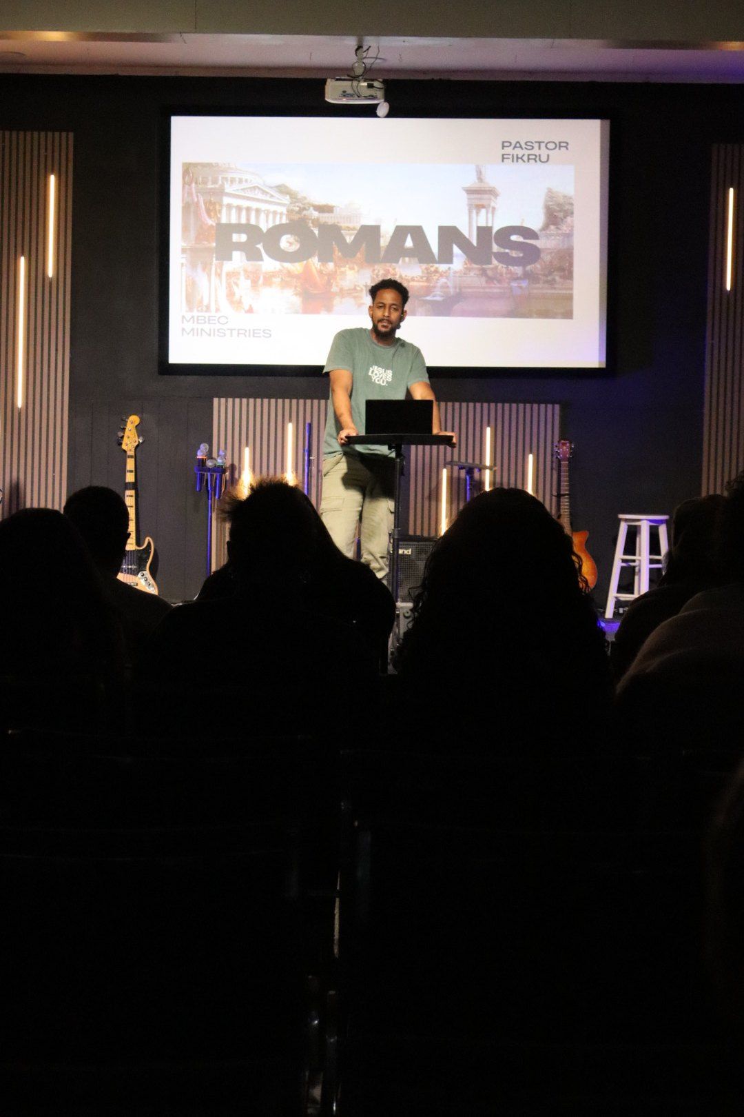 Pastor preaching from Romans
